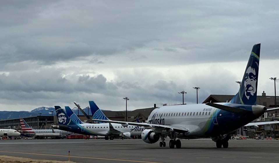 Alaska Airlines aircraft & aircraft at boarding bridge